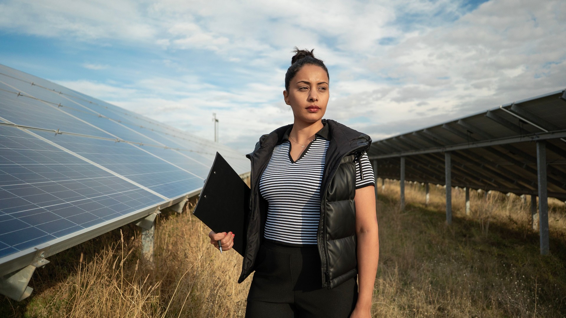 Portrait of energy engineer woman near solar panels